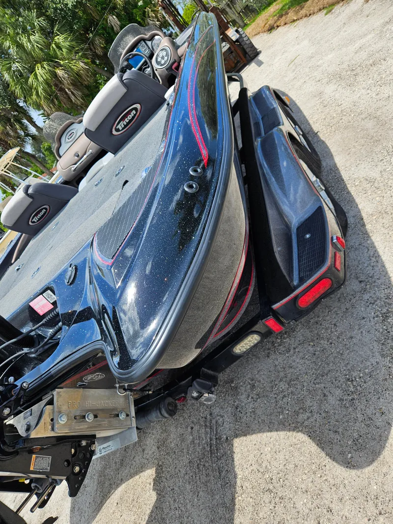 Slide: The Image of 2006 Triton Tr-21X HP boat on trailer, sleek design, outdoor setting. - 5