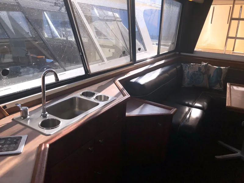 Slide: The Image of Interior of 1996 Bayliner 4788 Pilot House Motoryacht with sink and seating area. - 16