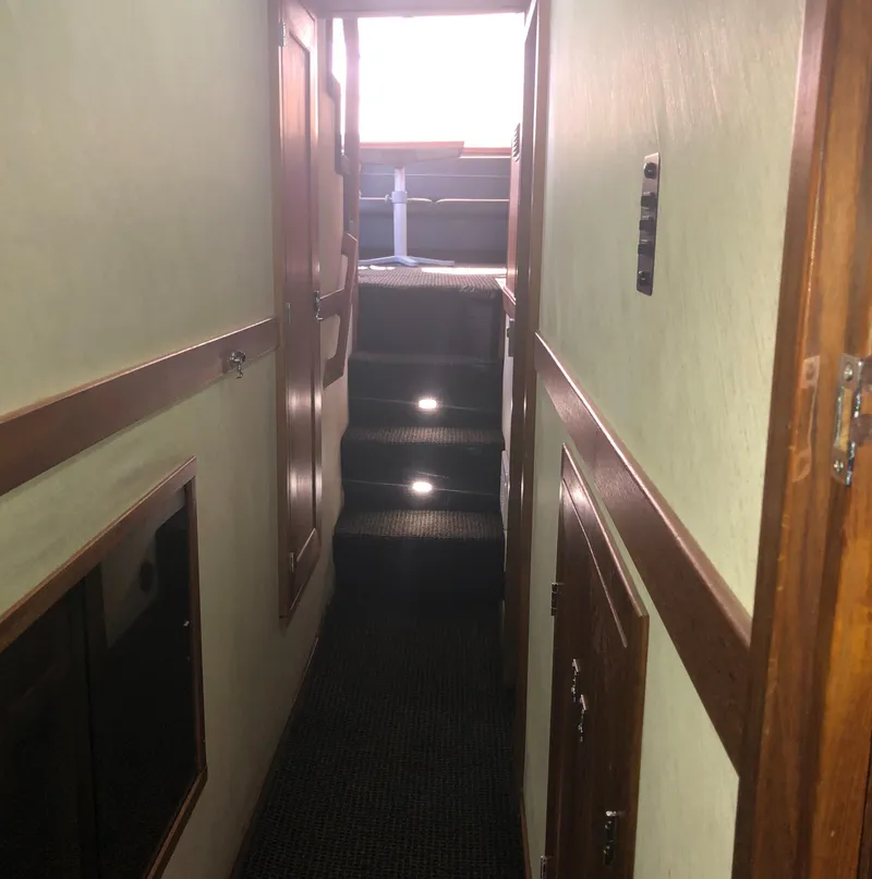 Slide: The Image of Interior hallway of 1996 Bayliner 4788 Pilot House Motoryacht with carpeted stairs. - 26