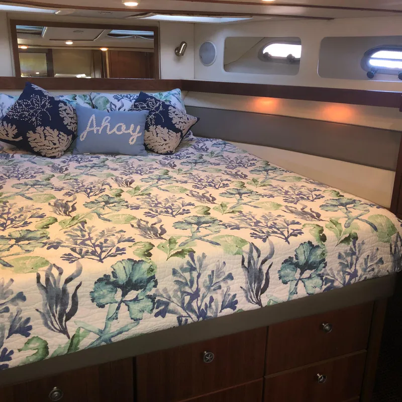 Slide: The Image of Luxurious bedroom in 1996 Bayliner 4788 Pilot House Motoryacht with nautical-themed bedding. - 29