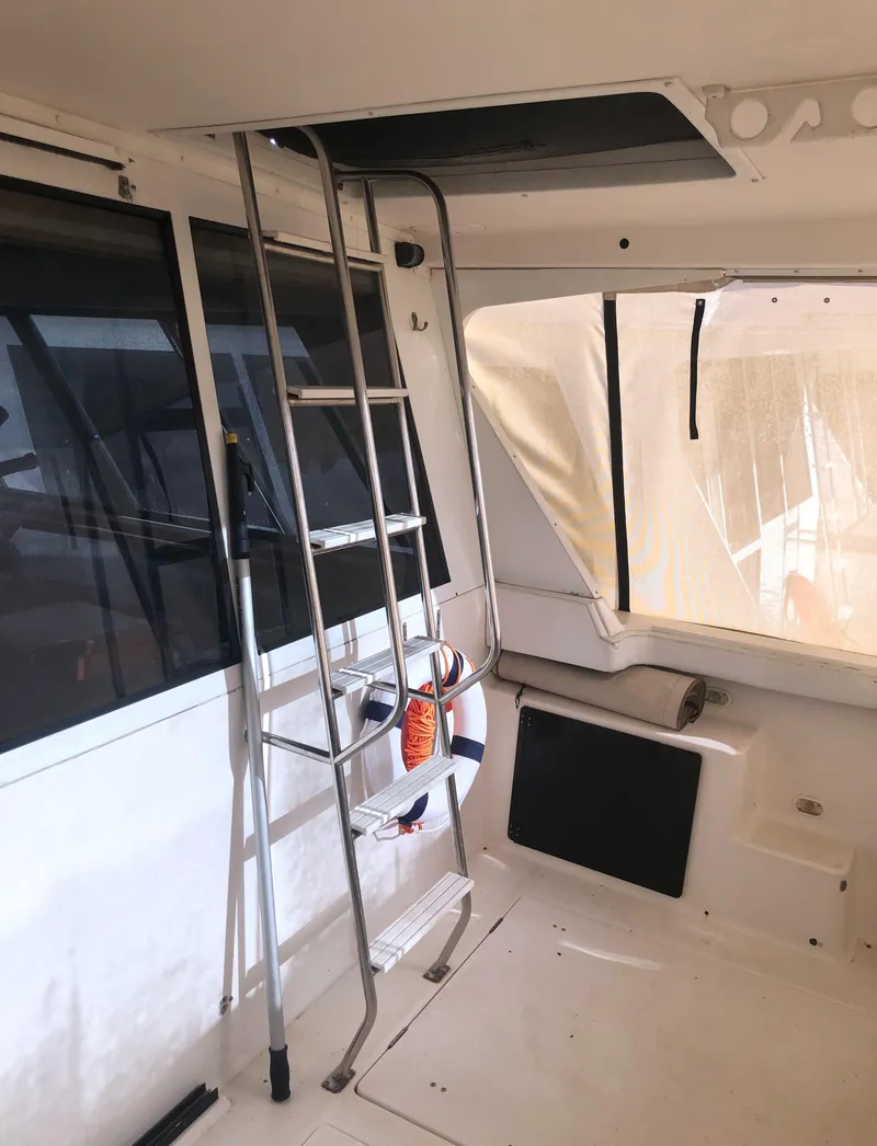 Slide: The Image of Interior view of 1996 Bayliner 4788 Pilot House Motoryacht with ladder and windows. - 3