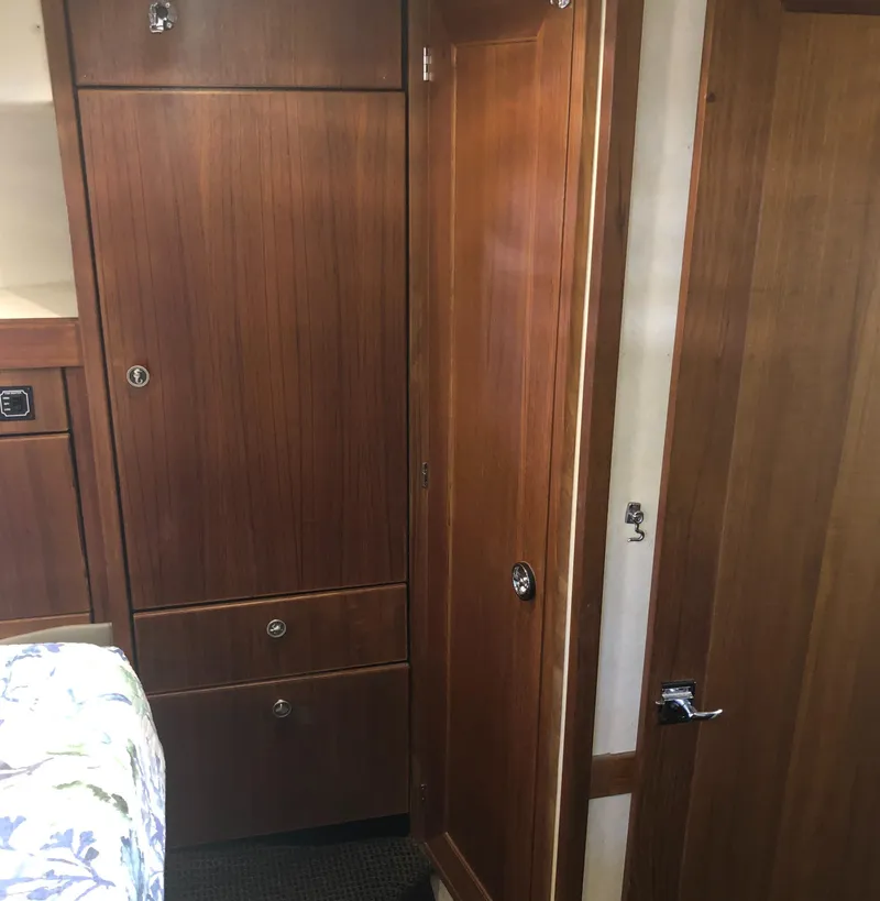 Slide: The Image of Interior of 1996 Bayliner 4788 Pilot House Motoryacht with wooden cabinetry and door. - 30