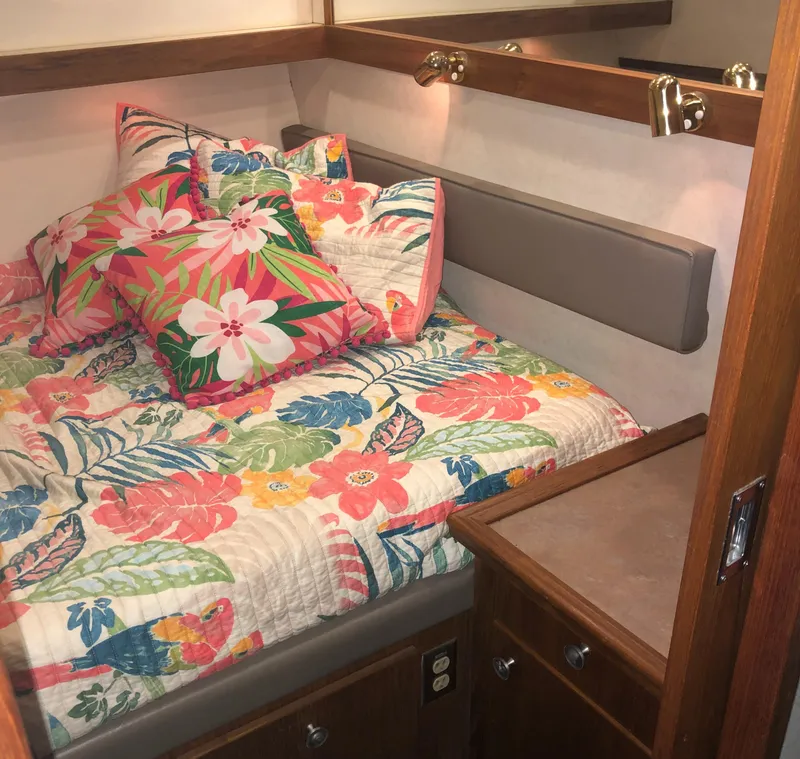 Slide: The Image of Cozy bedroom in 1996 Bayliner 4788 yacht with floral bedding and wooden cabinetry. - 36