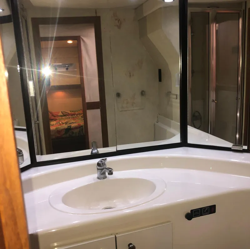 Slide: The Image of Bathroom interior of 1996 Bayliner 4788 Pilot House Motoryacht, featuring sink and mirror. - 38