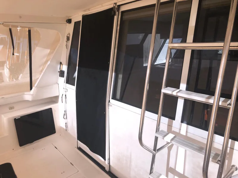 Slide: The Image of 1996 Bayliner 4788 Pilot House Motoryacht interior with ladder and windows. - 4