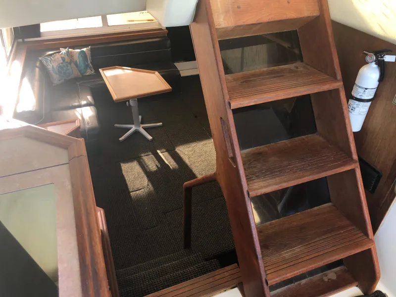 Slide: The Image of Interior of 1996 Bayliner 4788 Pilot House Motoryacht with wooden stairs and seating area. - 40