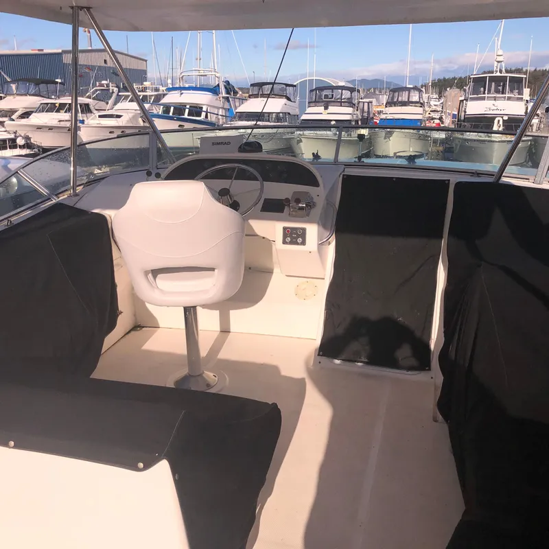 Slide: The Image of 1996 Bayliner 4788 Pilot House Motoryacht interior with helm and marina view. - 41