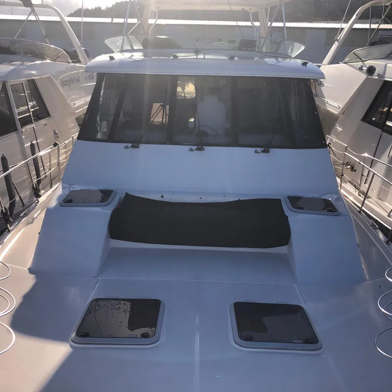 Slide: The Image of 1996 Bayliner 4788 Pilot House Motoryacht docked between two boats. - 46