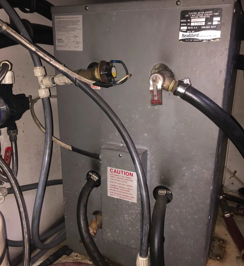 Slide: The Image of Engine compartment of a 1996 Bayliner 4788 Pilot House Motoryacht with visible hoses and components. - 49