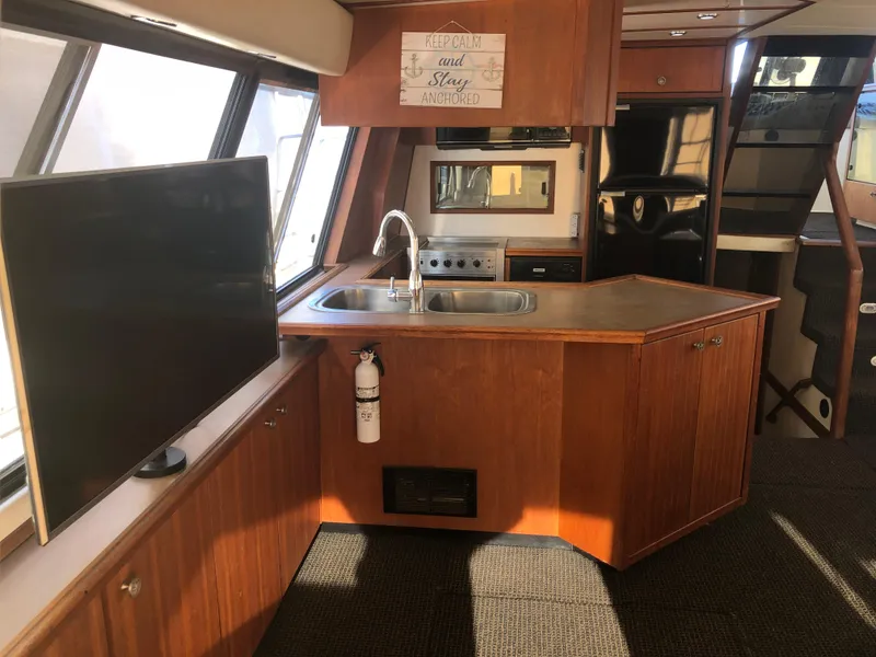 Slide: The Image of Interior of 1996 Bayliner 4788 Pilot House Motoryacht with kitchen and TV. - 5