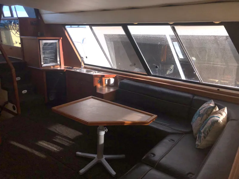 Slide: The Image of Interior of 1996 Bayliner 4788 Pilot House Motoryacht with seating and table. - 6