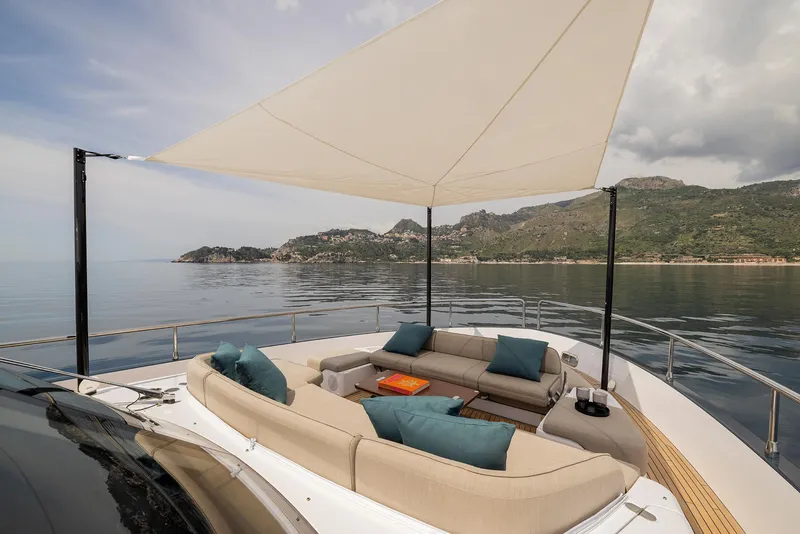 Slide: The Image of Luxurious 2025 Azimut Magellano 60 yacht with elegant outdoor seating and scenic ocean view. - 49