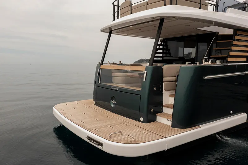 Slide: The Image of 2025 Azimut Magellano 60 yacht, rear view, elegant design on calm water. - 6