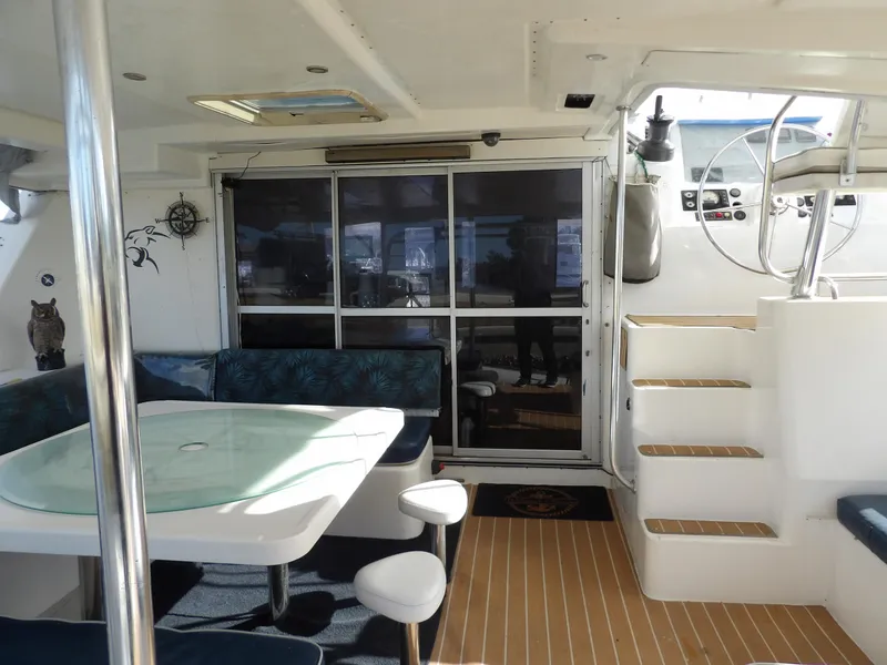 Slide: The Image of Leopard 48 yacht interior, featuring dining area and helm, 2014 model. - 17