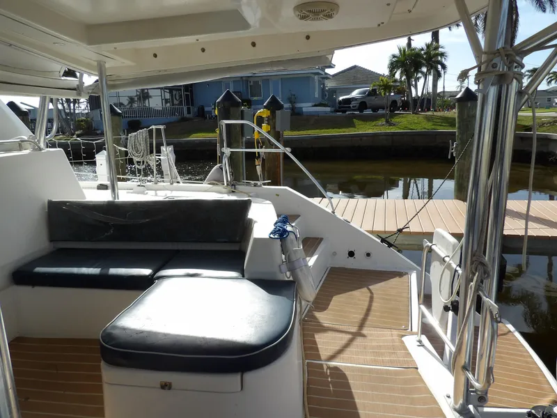 Slide: The Image of Leopard 48 yacht deck with seating, docked by waterfront homes, 2014 model. - 19