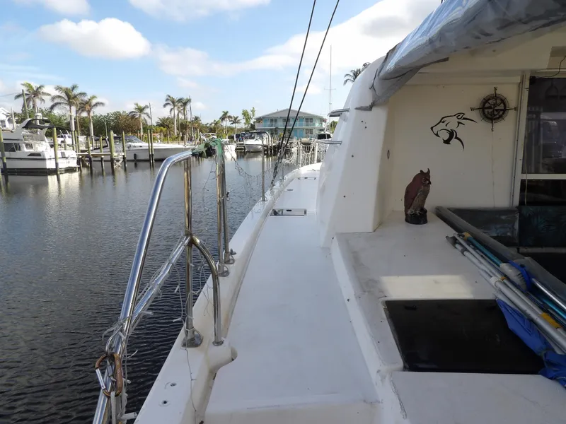 Slide: The Image of Leopard 48 yacht docked at marina, 2014 model, with clear skies and palm trees. - 21