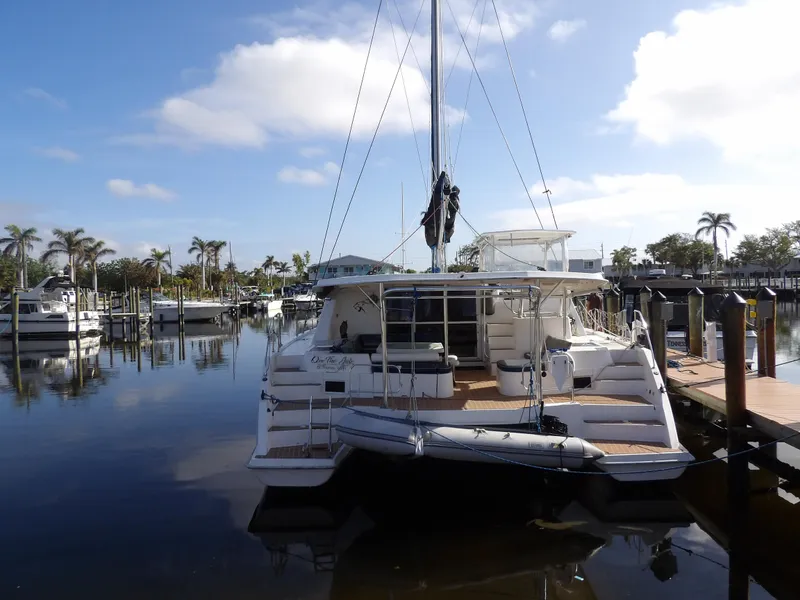 Slide: The Image of 2014 Leopard 48 catamaran docked in a sunny marina with palm trees. - 3