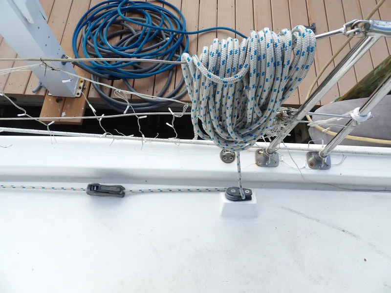 Slide: The Image of Coiled rope on Leopard 48 sailboat deck, 2014 model, with dock in background. - 31