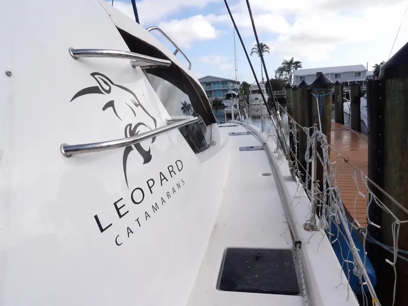Slide: The Image of Leopard 48 catamaran docked, showcasing sleek design and logo, 2014 model. - 32