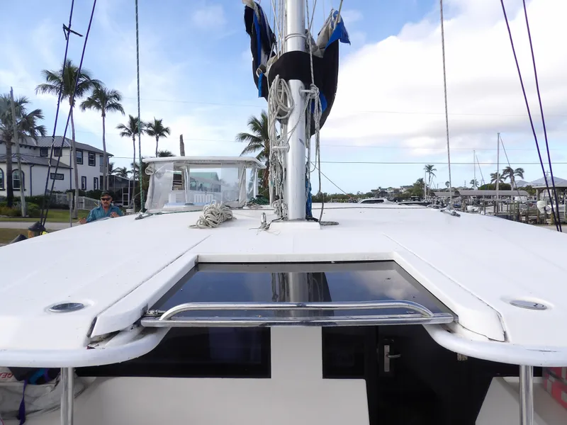 Slide: The Image of Leopard 48 catamaran deck view, 2014 model, docked with palm trees in the background. - 36