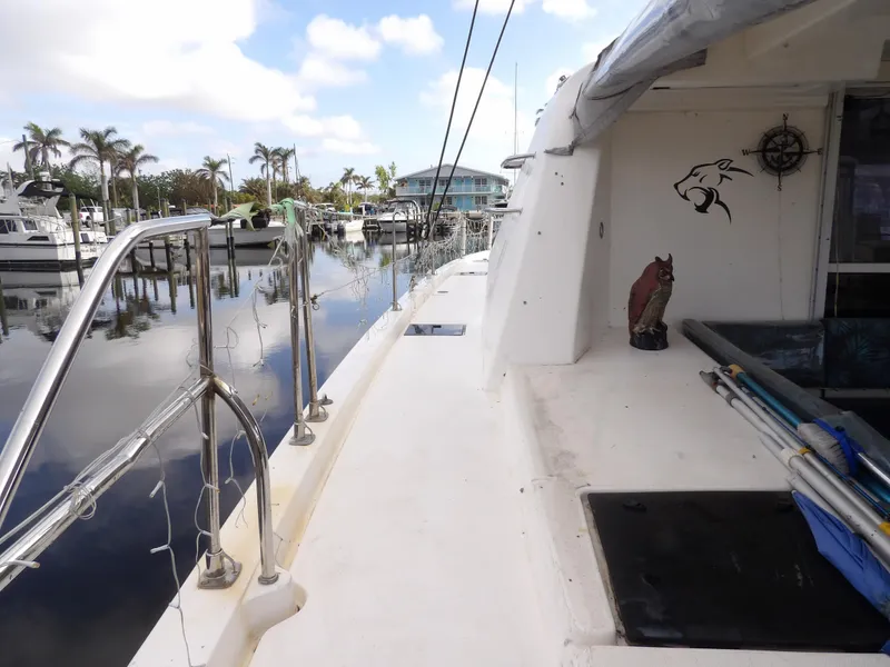 Slide: The Image of Leopard 48 yacht docked at marina, 2014 model, with clear skies and palm trees. - 37