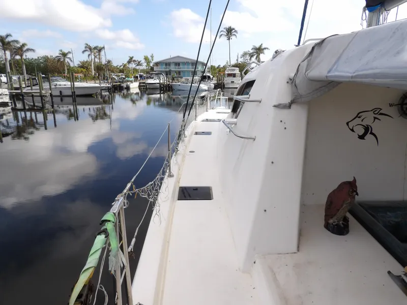 Slide: The Image of Leopard 48 catamaran docked in a marina, 2014 model, calm water reflections. - 38