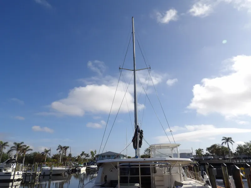 Slide: The Image of 2014 Leopard 48 yacht docked under a clear blue sky. - 4