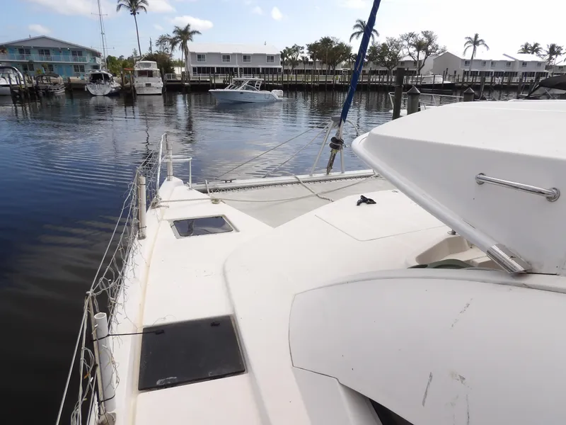 Slide: The Image of Leopard 48 catamaran docked in a marina, 2014 model, with waterfront view. - 44