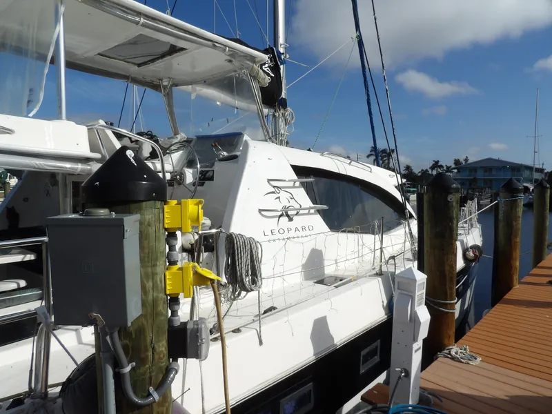 Slide: The Image of 2014 Leopard 48 yacht docked at marina under clear blue sky. - 8