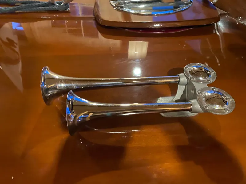 Slide: The Image of Chrome boat horns on polished wood surface, Lyman 24 Sleeper Hardtop, 1962 model. - 11