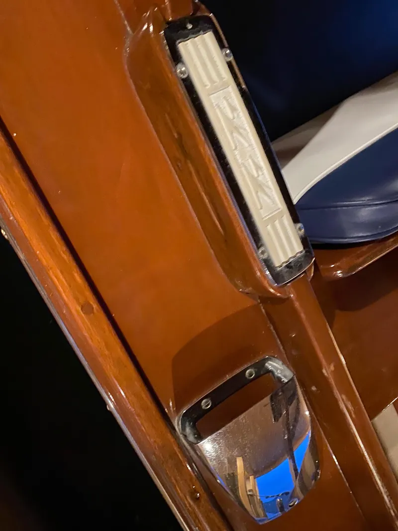 Slide: The Image of 1962 Lyman 24 Sleeper Hardtop interior detail with wood finish and blue seating. - 12