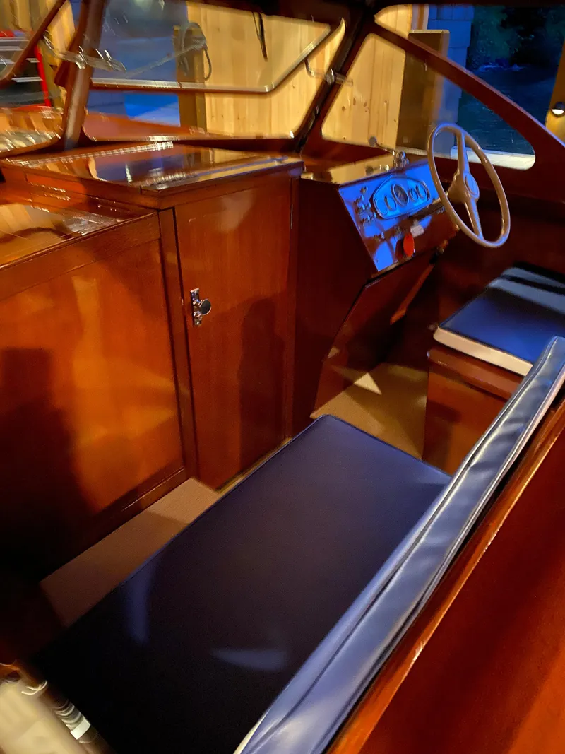 Slide: The Image of 1962 Lyman 24 Sleeper Hardtop interior with wooden finish and blue seating. - 13