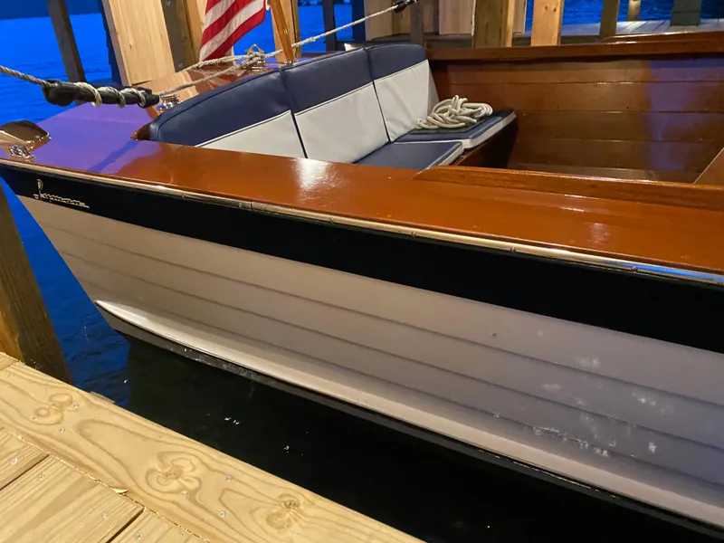 Slide: The Image of 1962 Lyman 24 Sleeper Hardtop boat with wooden interior and American flag. - 15