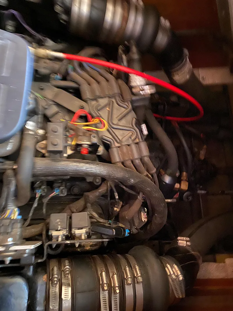 Slide: The Image of Engine compartment of a 1962 Lyman 24 Sleeper Hardtop boat, showcasing intricate mechanical components. - 32