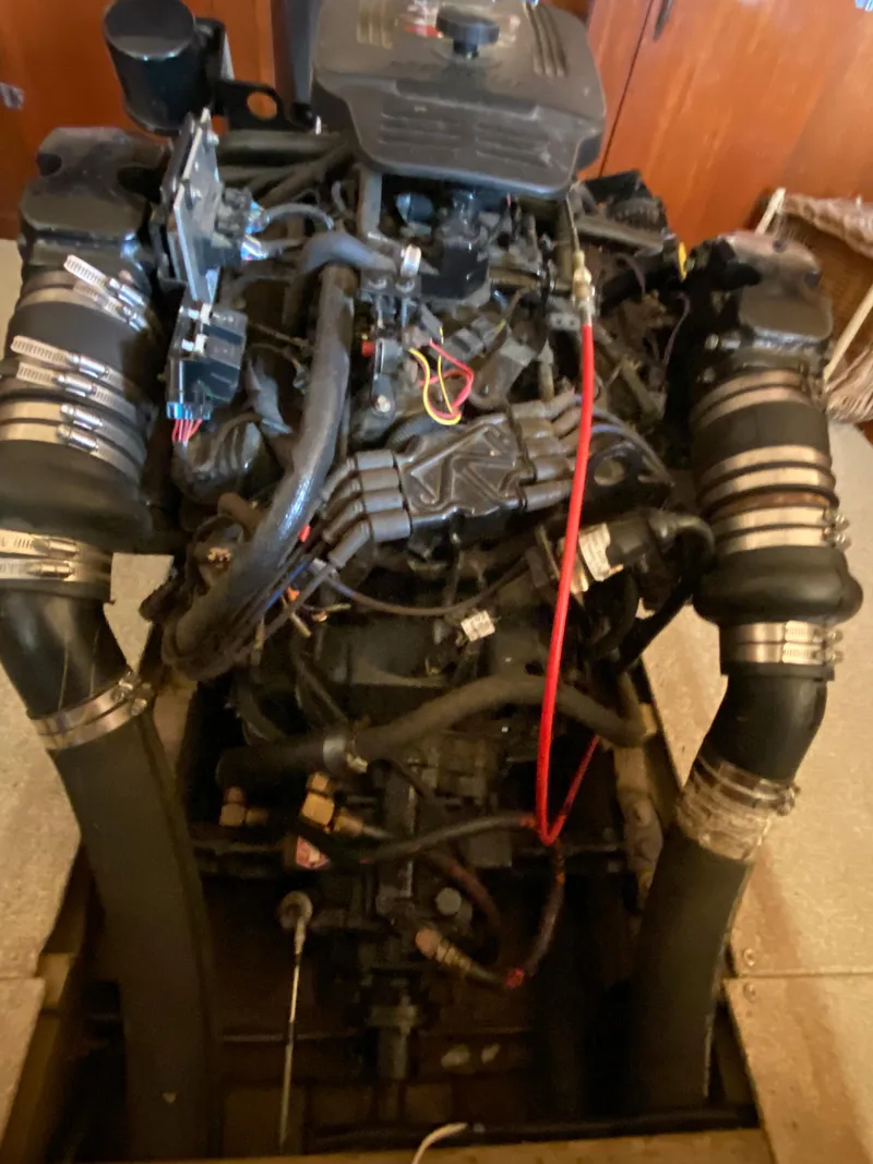 Slide: The Image of 1962 Lyman 24 Sleeper Hardtop engine with complex wiring and hoses. - 34