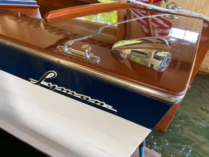 Slide: The Image of 1962 Lyman 24 Sleeper Hardtop boat with polished wood and chrome details. - 7