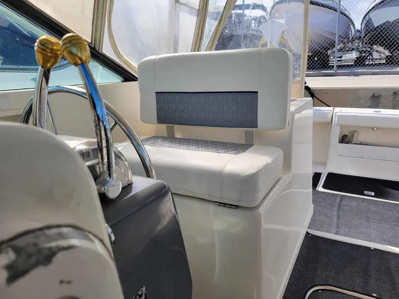 Slide: The Image of 1995 Tiara Yachts 3100 Open cockpit with steering wheel and seating. - 3
