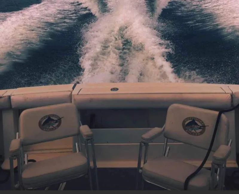 Slide: The Image of Tiara Yachts 3100 Open 1995, boat wake view with fishing chairs. - 5