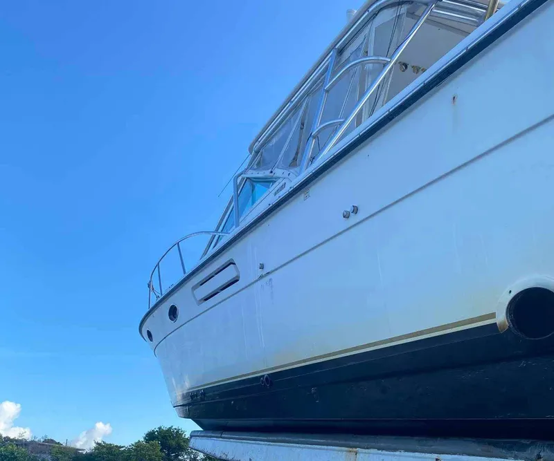 Slide: The Image of 1995 Tiara Yachts 3100 Open boat under clear blue sky. - 9