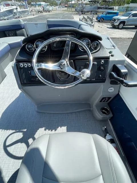 Slide: The Image of 2025 Berkshire 24RFX CTS3 boat dashboard with steering wheel and controls. - 11