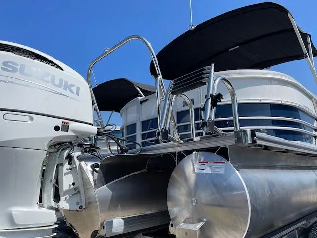 Slide: The Image of 2025 Berkshire 24RFX CTS3 pontoon boat with Suzuki outboard motor, featuring sleek design. - 12