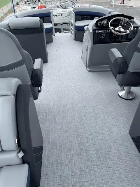 Slide: The Image of 2025 Berkshire 24RFX CTS3 boat interior with modern seating and sleek dashboard design. - 18