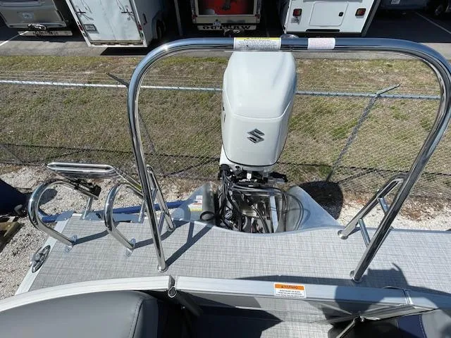 Slide: The Image of 2025 Berkshire 24RFX CTS3 pontoon boat with Suzuki outboard motor, rear view. - 8