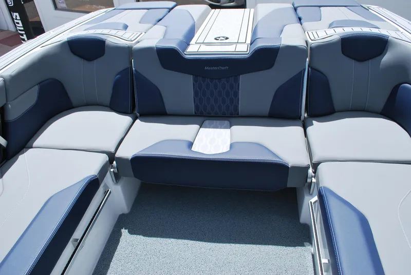 Slide: The Image of 2024 MasterCraft XT24 boat interior with blue and gray seating. - 11