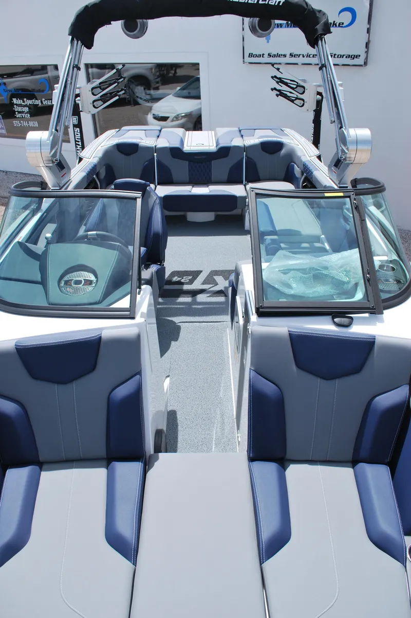 Slide: The Image of 2024 MasterCraft XT24 boat interior with blue and gray seating, open deck layout. - 3