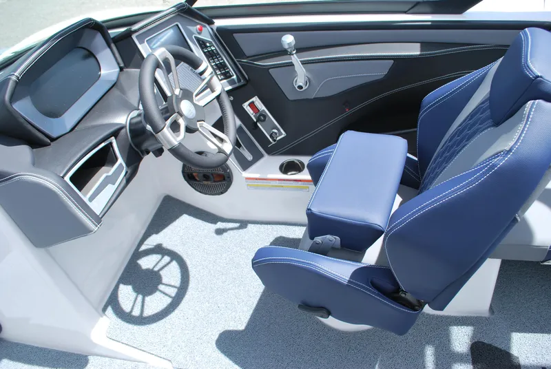 Slide: The Image of 2024 MasterCraft XT24 boat interior with modern dashboard and blue seating. - 4