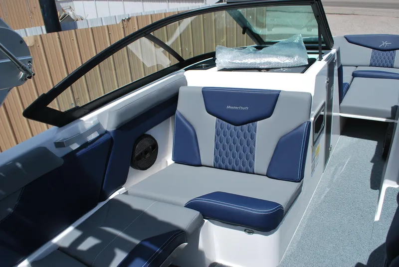 Slide: The Image of 2024 MasterCraft XT24 boat interior with blue and gray seating. - 6
