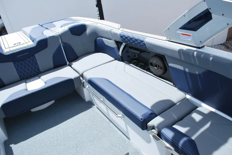 Slide: The Image of 2024 MasterCraft XT24 boat interior with blue and gray seating. - 7