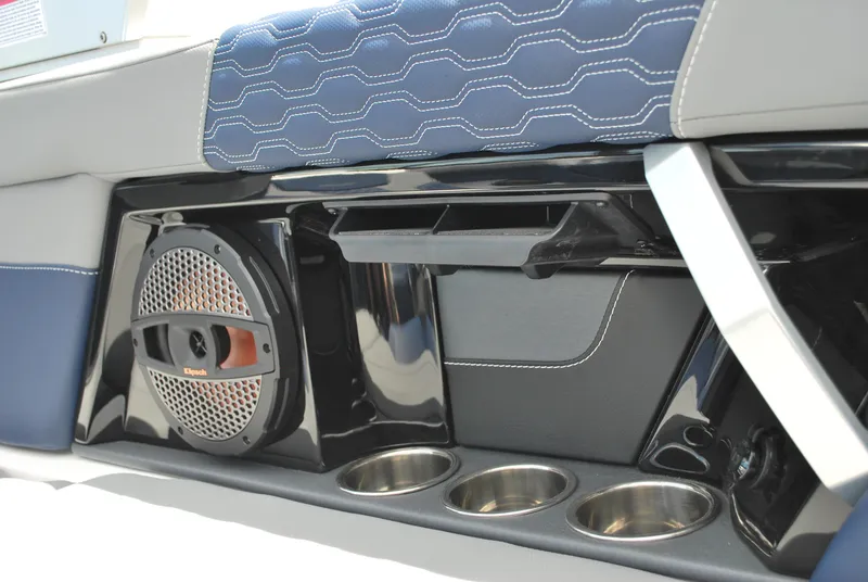 Slide: The Image of 2024 MasterCraft XT24 interior with speaker, cup holders, and blue stitching. - 9