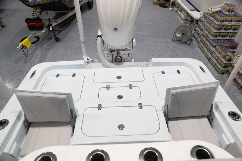 Slide: The Image of 2024 Contender 26 Bay boat deck with storage compartments and seating. - 5